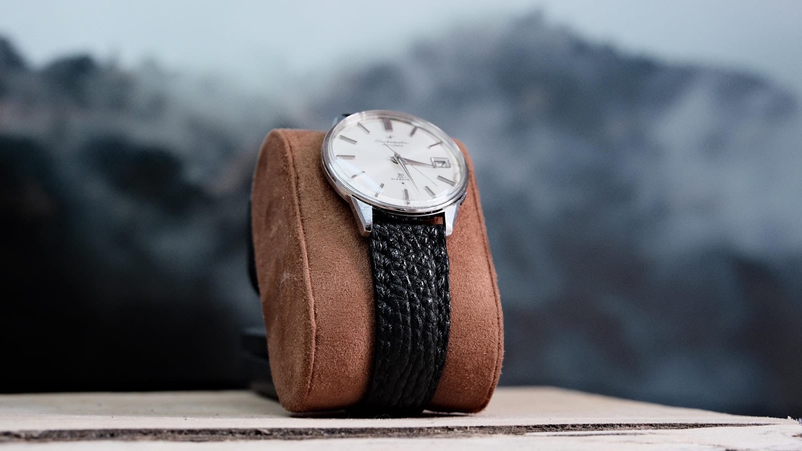 Quarante montres alignées sur un plateau de feutre gris, étiquettes de prix retournées à côté de chaque boîtier